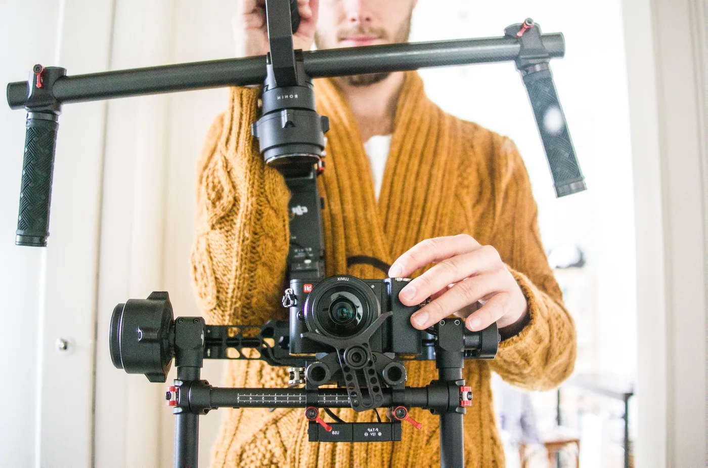 Videographer holding a camera on a gimbal